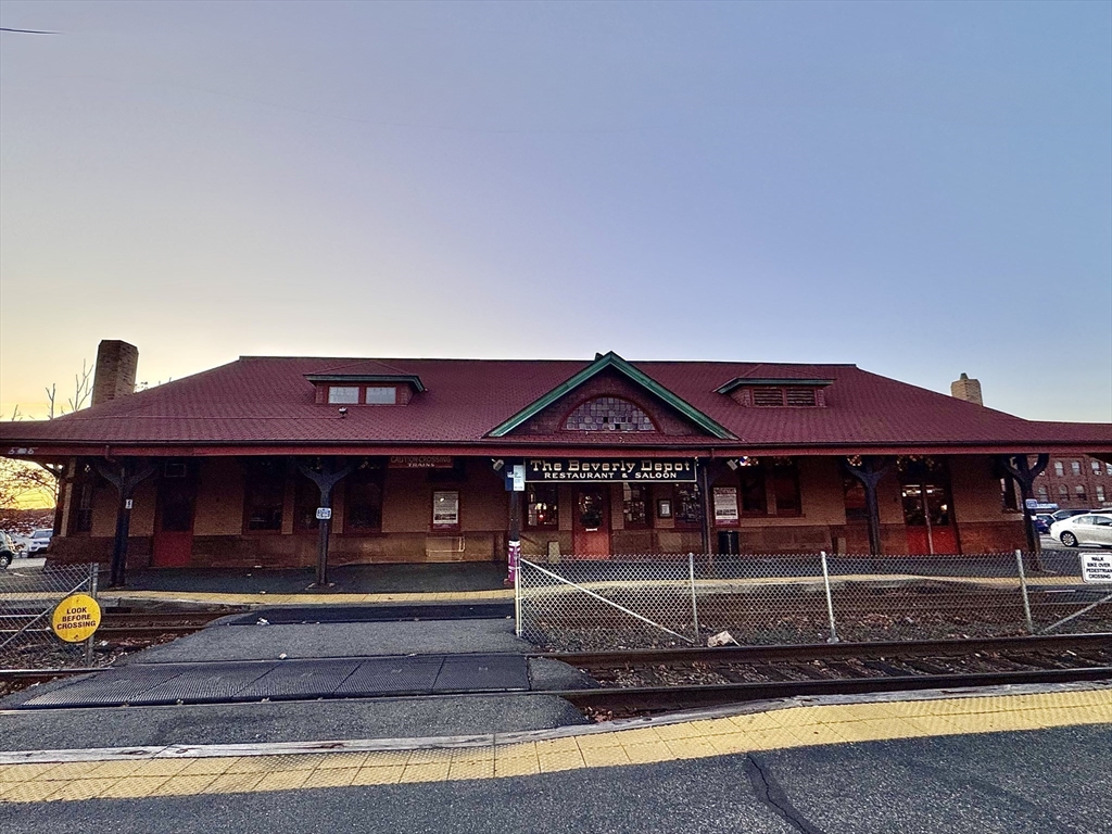 7 Hardy Street, Unit 1 Beverly, MA 01915 - Photo 21 of 24 a front view of a house with a garden