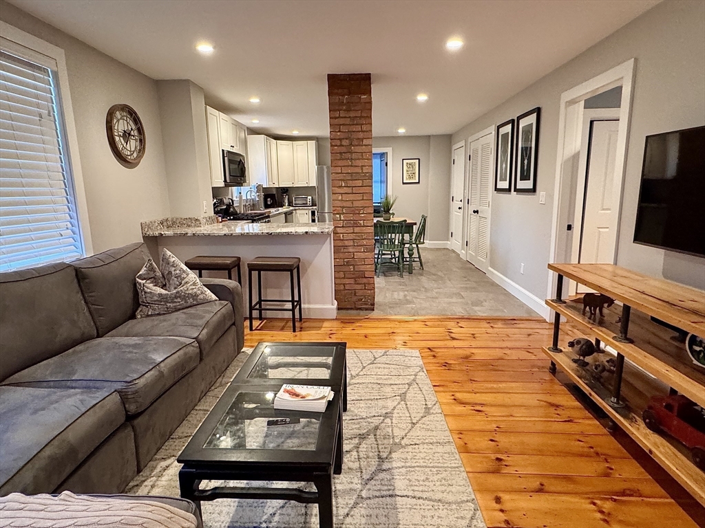 7 Hardy Street, Unit 1 Beverly, MA 01915 - Photo 4 of 24 a living room with furniture and a flat screen tv