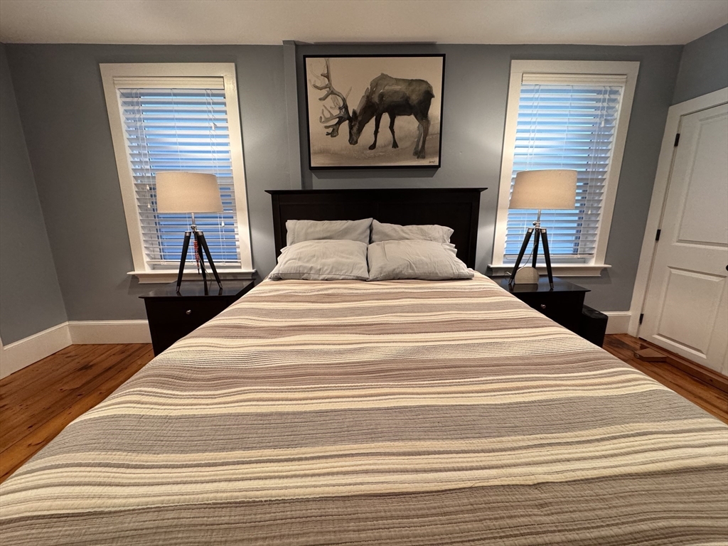 7 Hardy Street, Unit 1 Beverly, MA 01915 - Photo 10 of 24 a bedroom with bed and wooden floor