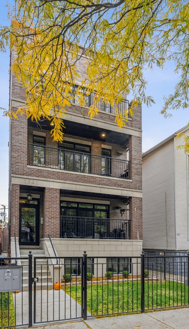 1341 West George Street, Unit 1 Chicago, IL 60657 - Photo 1 of 24 front view of a house with a small yard
