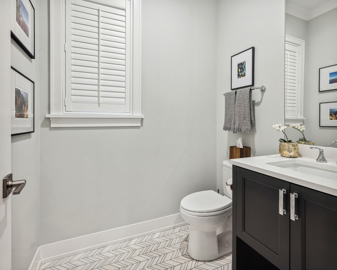 1341 West George Street, Unit 1 Chicago, IL 60657 - Photo 11 of 24 a bathroom with a granite countertop toilet a sink and a mirror