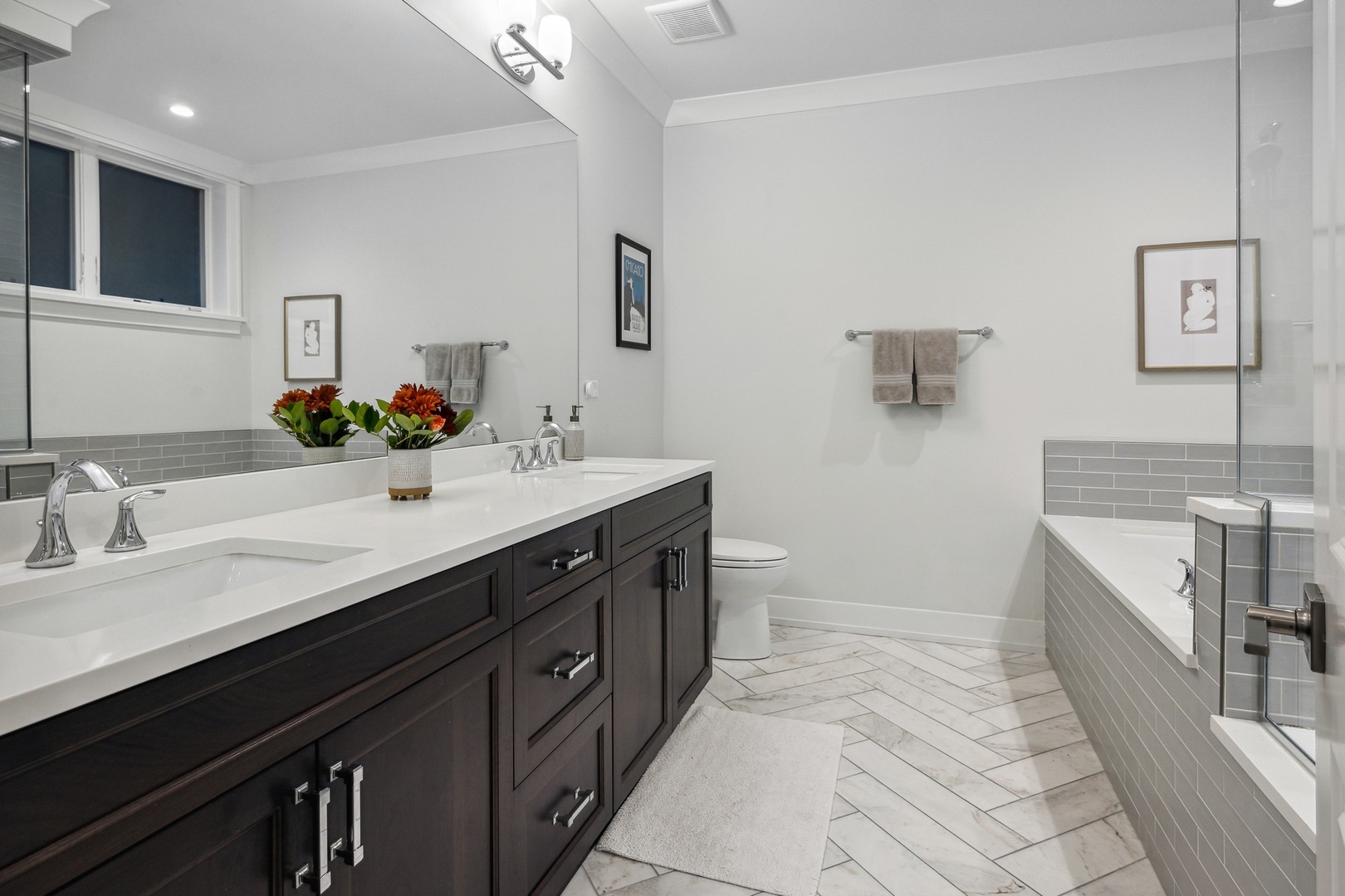 1341 West George Street, Unit 1 Chicago, IL 60657 - Photo 14 of 24 a spacious bathroom with a double vanity sink a mirror and a bathtub