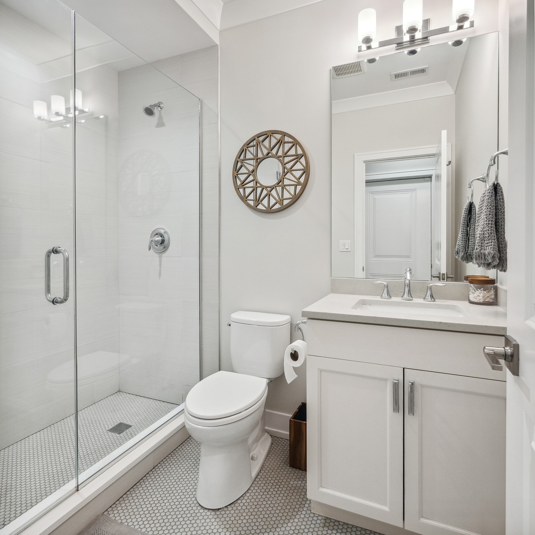 1341 West George Street, Unit 1 Chicago, IL 60657 - Photo 18 of 24 a bathroom with a toilet a sink and a mirror