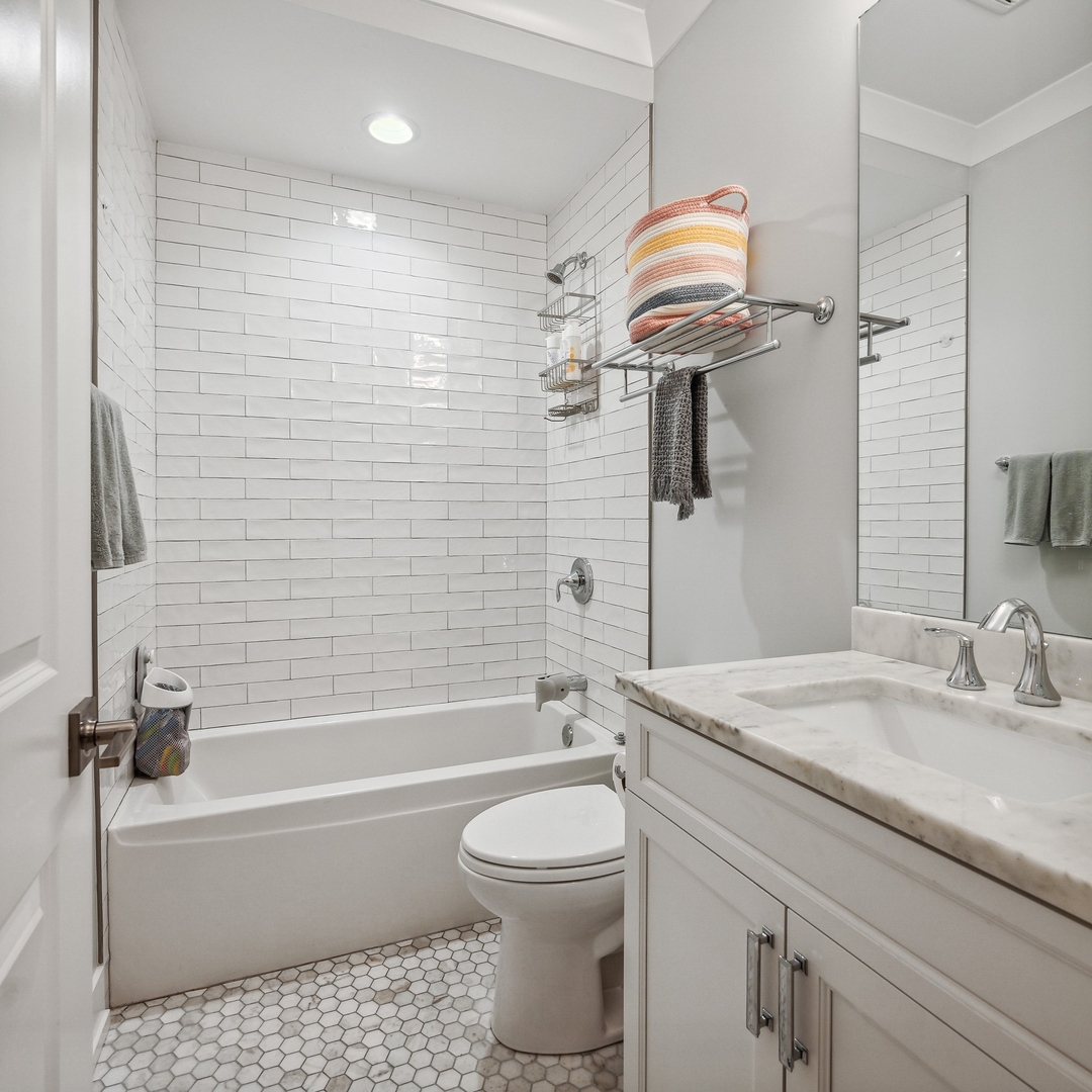1341 West George Street, Unit 1 Chicago, IL 60657 - Photo 20 of 24 a bathroom with a sink a toilet and shower