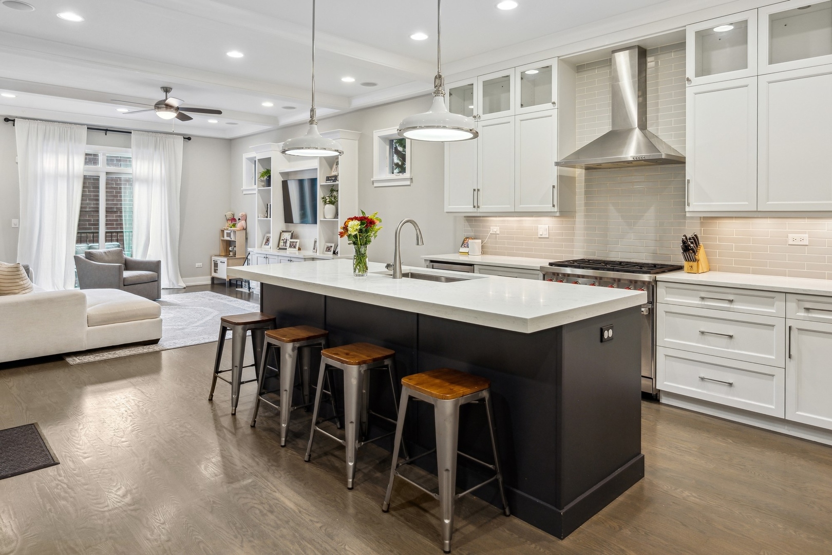1341 West George Street, Unit 1 Chicago, IL 60657 - Photo 7 of 24 a kitchen with a stove a sink a dining table and chairs