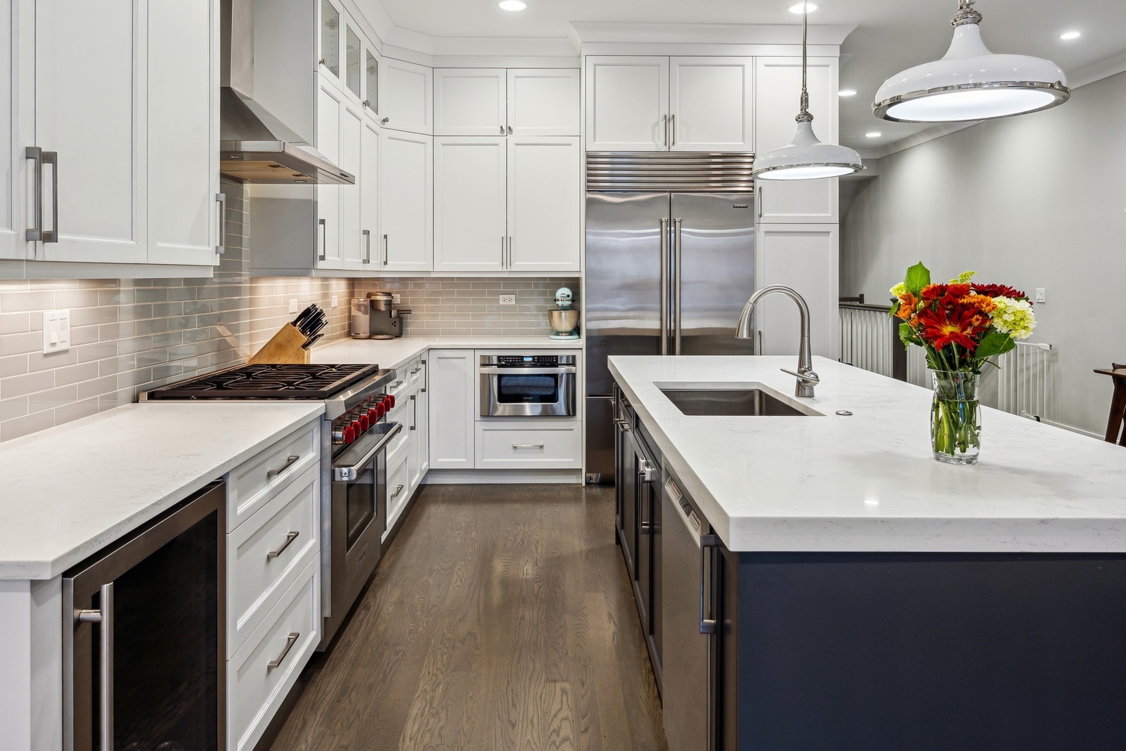 1341 West George Street, Unit 1 Chicago, IL 60657 - Photo 9 of 24 a kitchen with stainless steel appliances granite countertop a sink stove and refrigerator