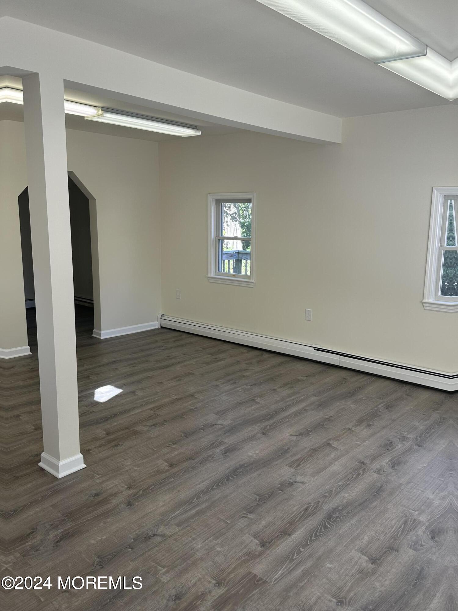 1 Leonardville Road, Unit C Middletown, NJ 07748 - Photo 9 of 12 a view of an empty room with wooden floor and a window