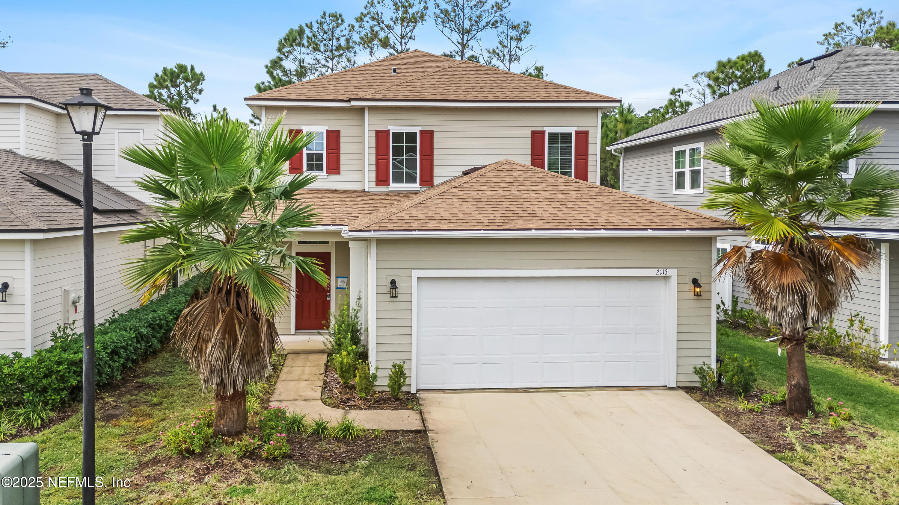 2113 Hawkeye Place Fleming Island, FL 32003 - Photo 1 of 30 a front view of a house with a yard and garage