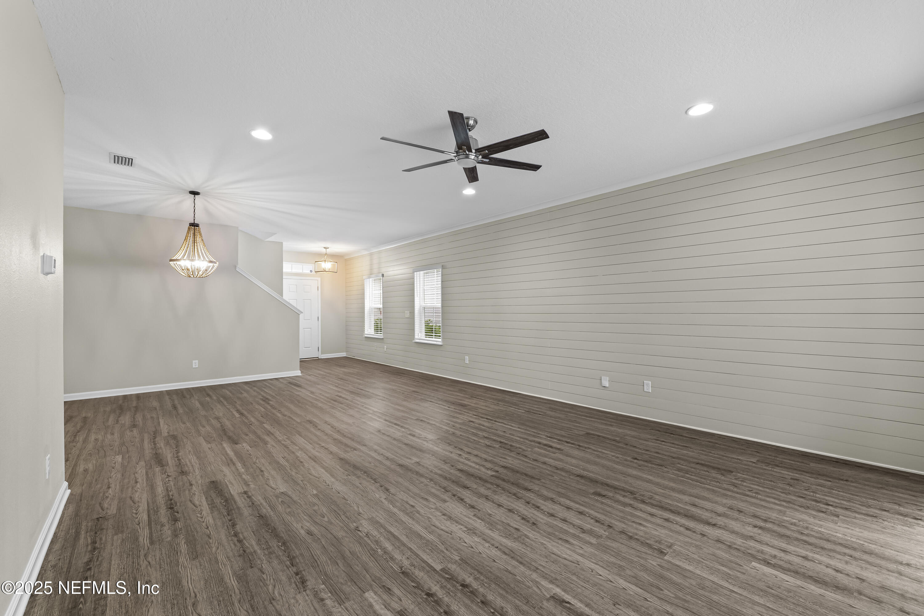 2113 Hawkeye Place Fleming Island, FL 32003 - Photo 11 of 30 an empty room with wooden floor and windows