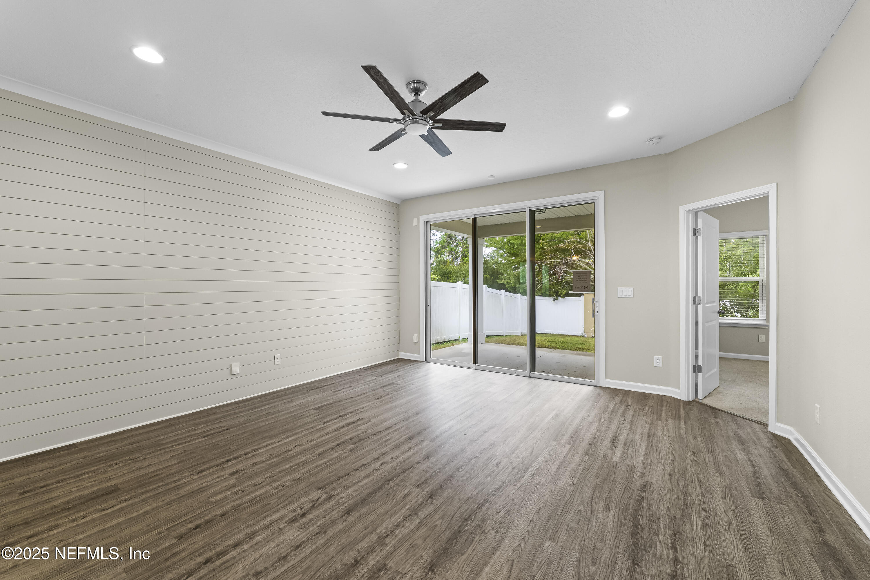 2113 Hawkeye Place Fleming Island, FL 32003 - Photo 12 of 30 a view of an empty room with wooden floor and a window