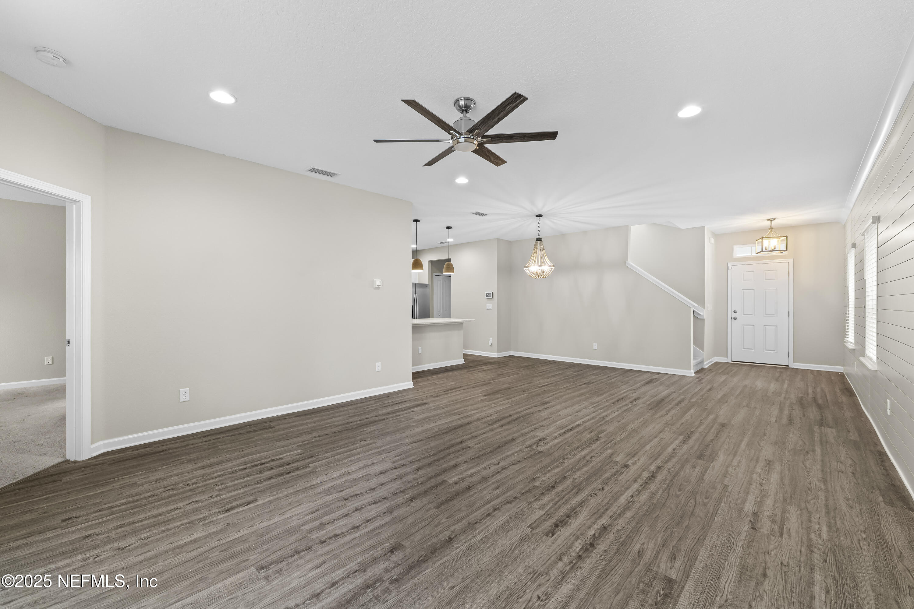 2113 Hawkeye Place Fleming Island, FL 32003 - Photo 13 of 30 a view of an empty room with wooden floor and a ceiling fan