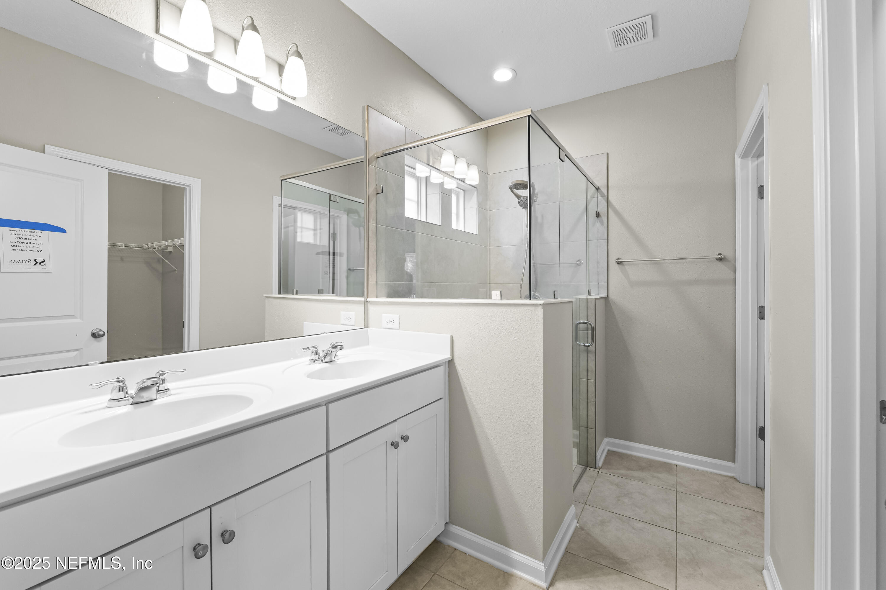 2113 Hawkeye Place Fleming Island, FL 32003 - Photo 16 of 30 a bathroom with a double vanity sink and a mirror