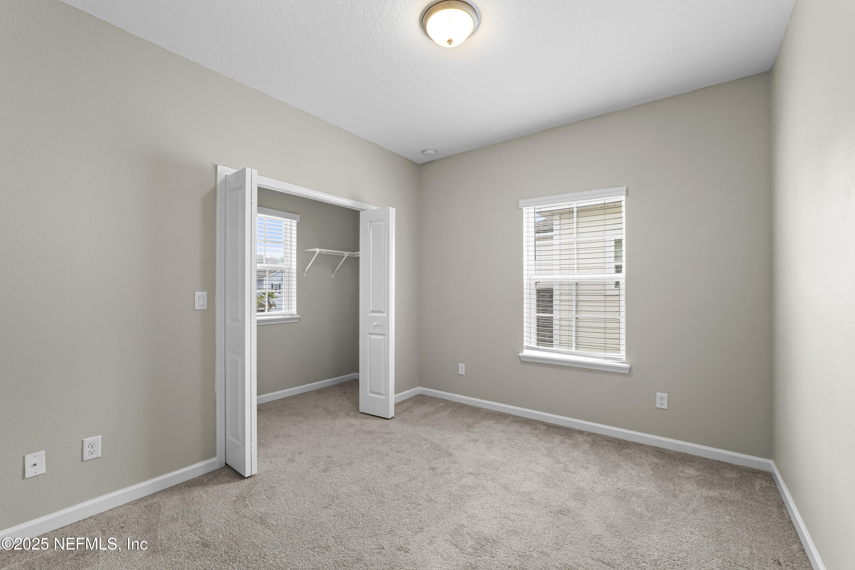 2113 Hawkeye Place Fleming Island, FL 32003 - Photo 25 of 30 an empty room with windows and closet