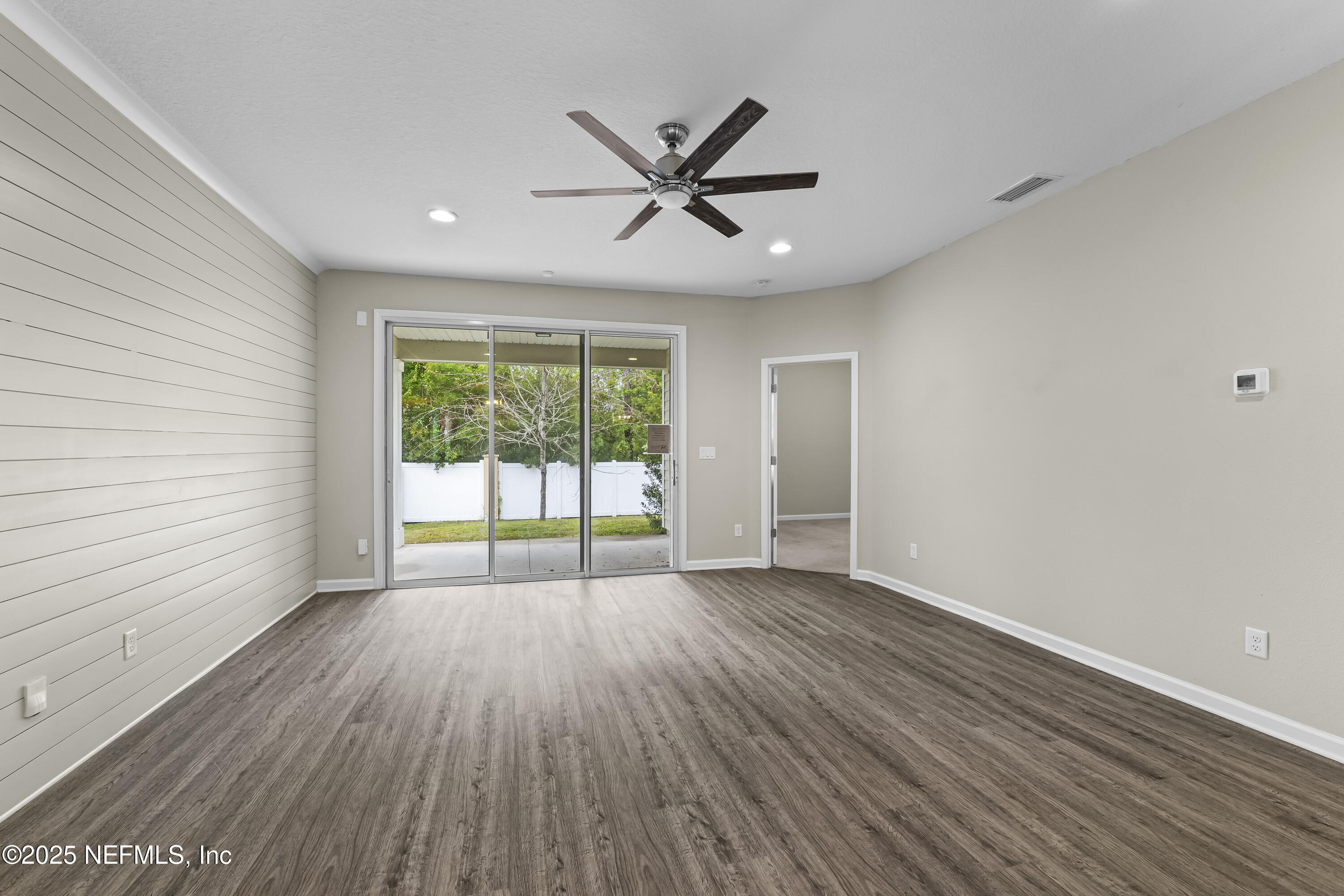 2113 Hawkeye Place Fleming Island, FL 32003 - Photo 10 of 30 wooden floor in an empty room with a window