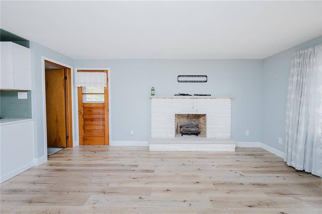 89 Marcoline Road Home, PA 15747 - Photo 14 of 47 a view of an empty room with wooden floor and a window