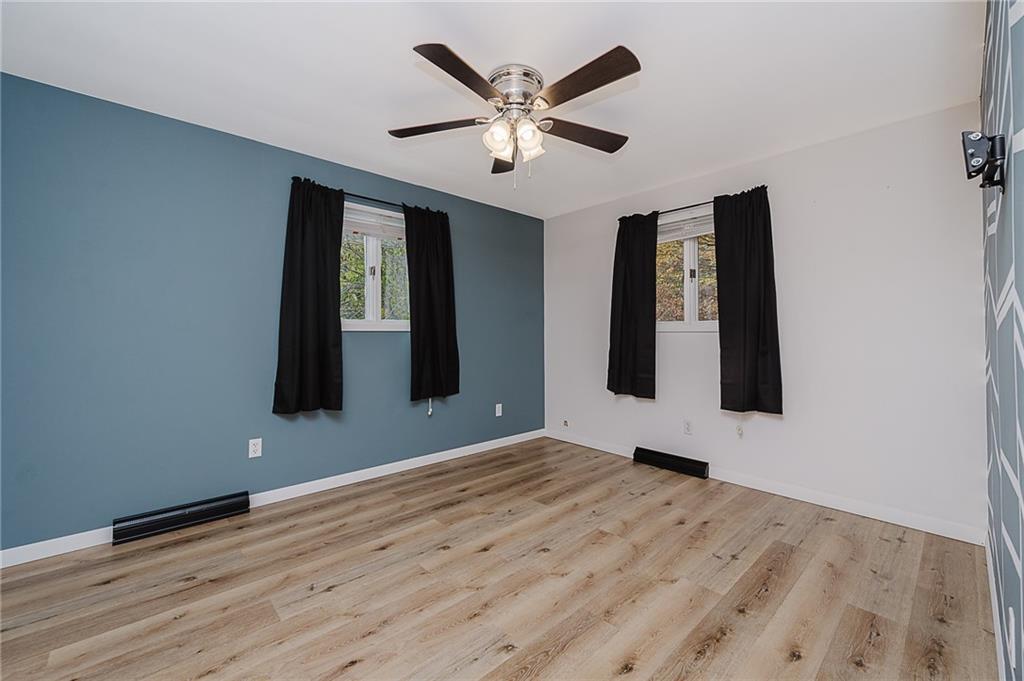 89 Marcoline Road Home, PA 15747 - Photo 17 of 47 a view of an empty room with window and wooden floor