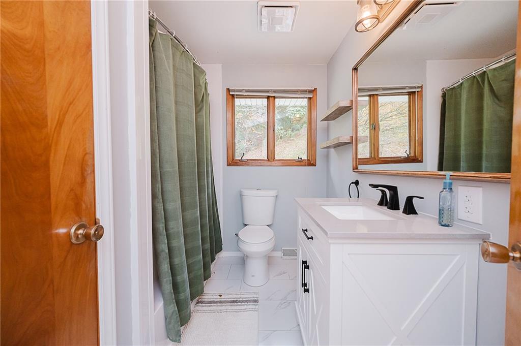 89 Marcoline Road Home, PA 15747 - Photo 22 of 47 a bathroom with a sink a toilet and a mirror
