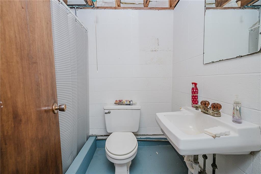 89 Marcoline Road Home, PA 15747 - Photo 27 of 47 a white toilet sitting next to a bathroom sink