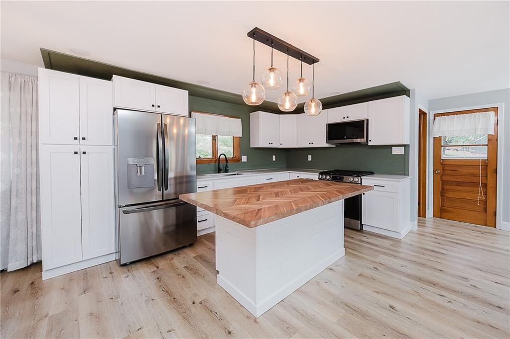 89 Marcoline Road Home, PA 15747 - Photo 3 of 47 a kitchen with stainless steel appliances granite countertop a refrigerator a stove a sink and a microwave