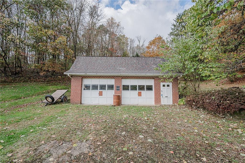 89 Marcoline Road Home, PA 15747 - Photo 31 of 47 a view of a white house with a big yard and large trees