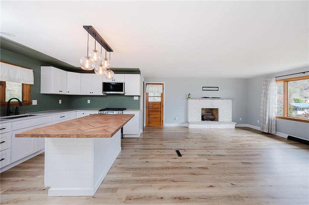 89 Marcoline Road Home, PA 15747 - Photo 10 of 47 a kitchen with granite countertop a stove and a sink