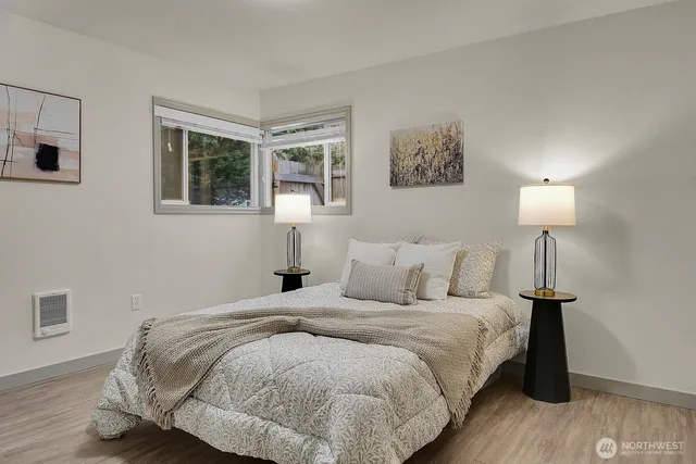 a bedroom with a bed and a night stand