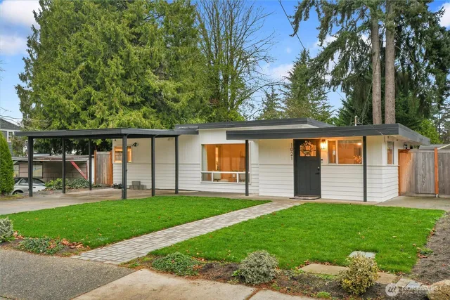 a view of a house with a yard and sitting area