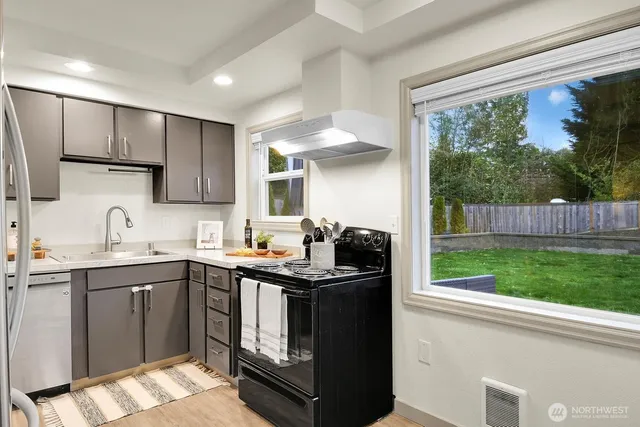 a kitchen with a sink stove and cabinets