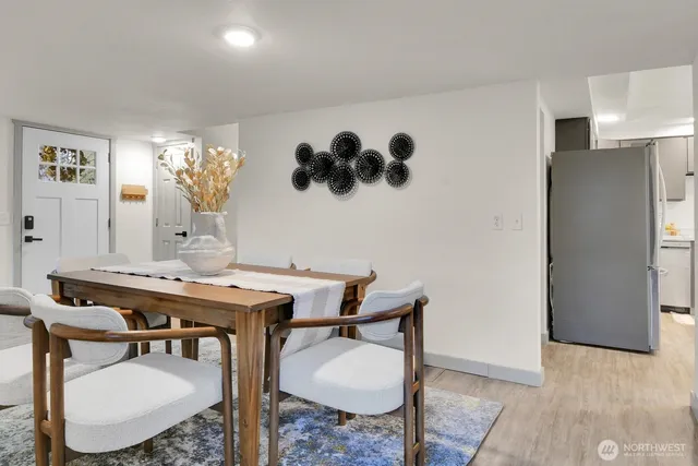 a room with a table chairs and kitchen view