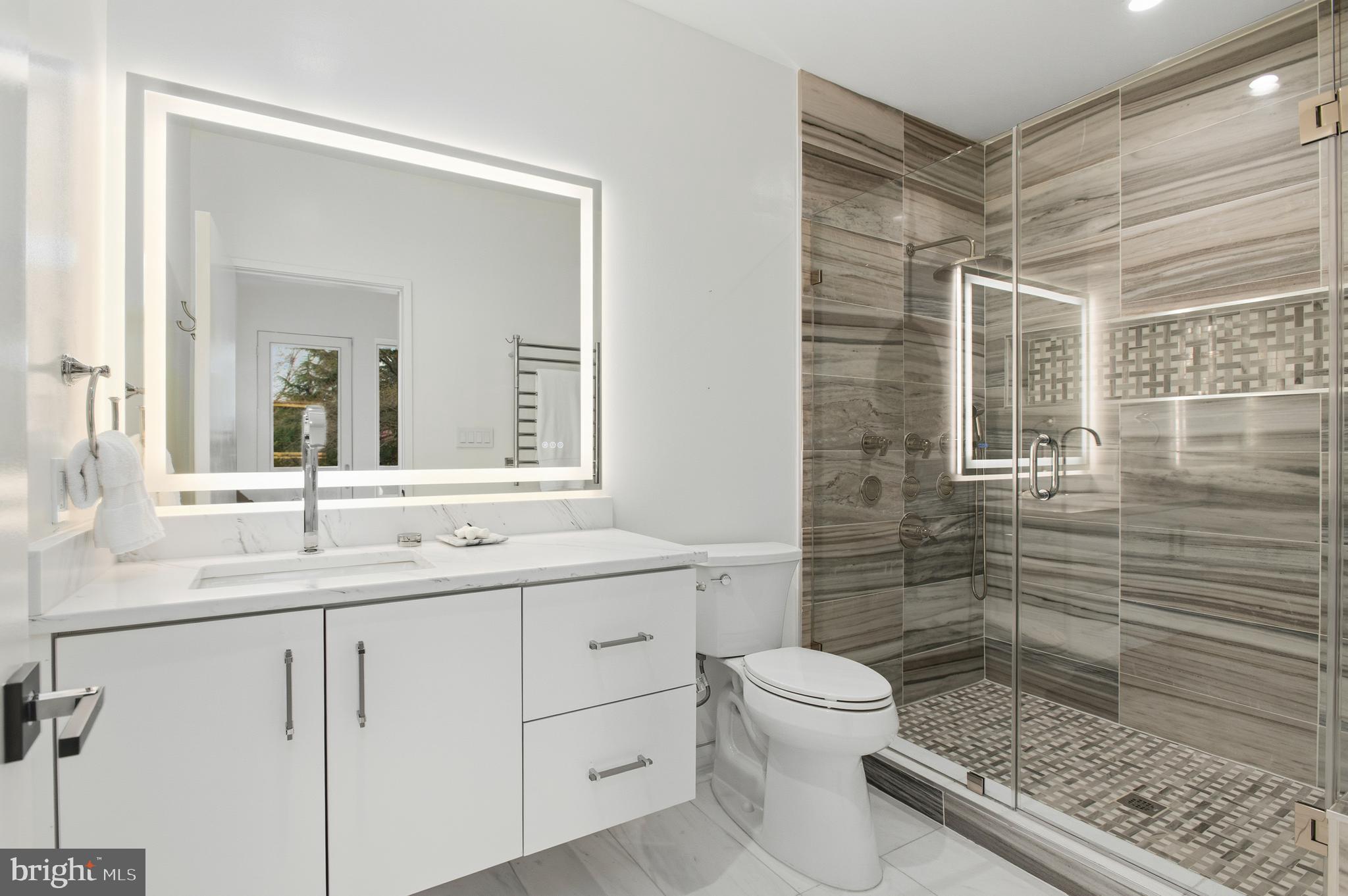 3001 Foxhall Road Northwest Washington, DC 20016 - Photo 32 of 51 a bathroom with a granite countertop sink toilet a mirror and shower