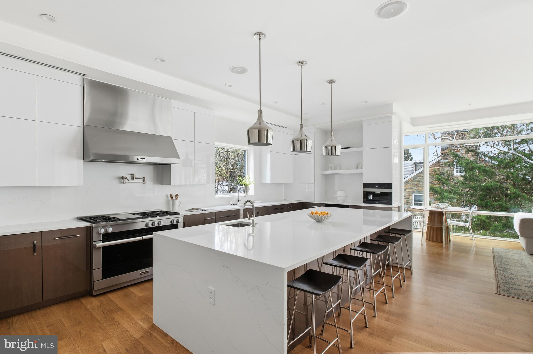 3001 Foxhall Road Northwest Washington, DC 20016 - Photo 4 of 51 a kitchen with stainless steel appliances a stove a sink a oven a dining table and chairs with wooden floor