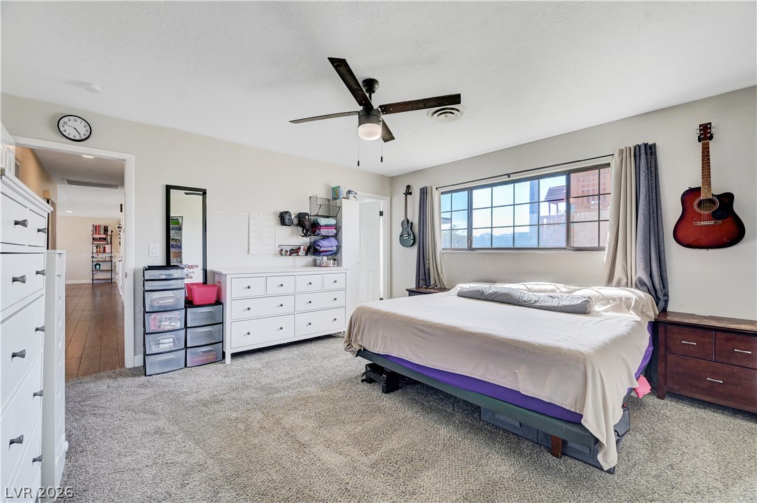 1331 Pinto Road Boulder City, NV 89005 - Photo 26 of 46 A naturally illuminated bedroom offers soft carpeting and a window with urban outlooks.