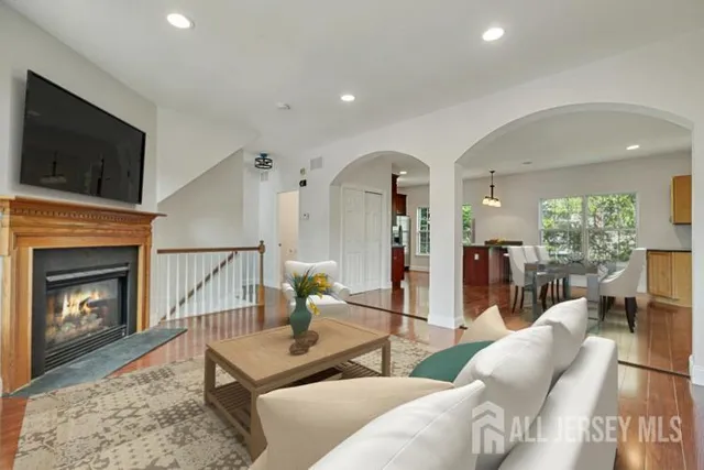 a living room with furniture a flat screen tv and a fireplace