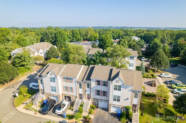an aerial view of a house with a yard
