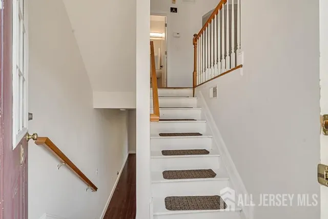 a view of staircase with white walls and a window