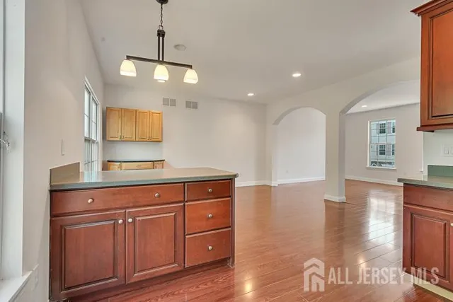 a view of a kitchen with cabinets and wooden floor