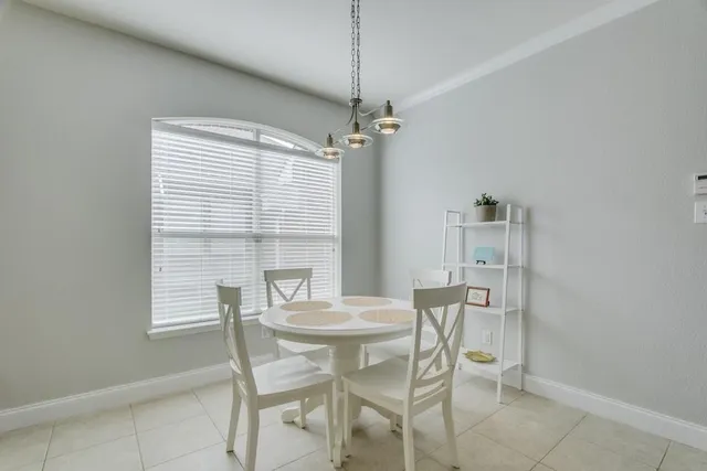 a dining room with furniture and window