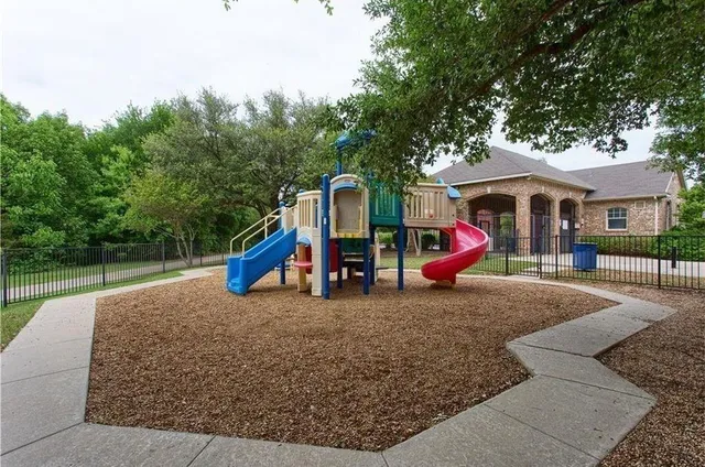 a view of outdoor space with playground and green space