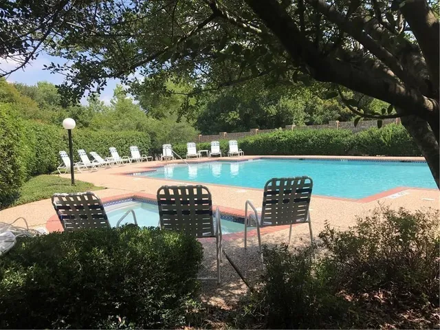 a view of a lake with couches and wooden fence