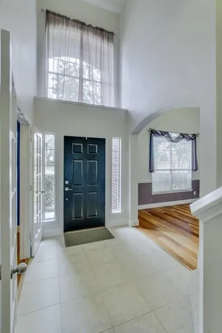 an empty room with windows and closet