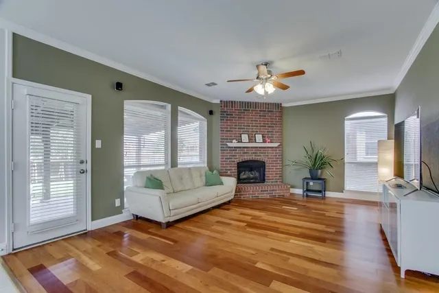 a living room with furniture a fireplace and a flat screen tv