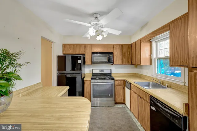 a kitchen with a stove a sink and a microwave