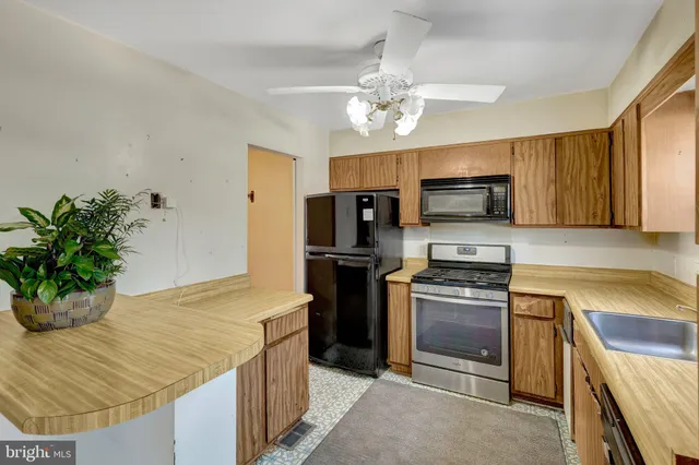 a kitchen with stainless steel appliances granite countertop a sink dishwasher stove top oven and refrigerator
