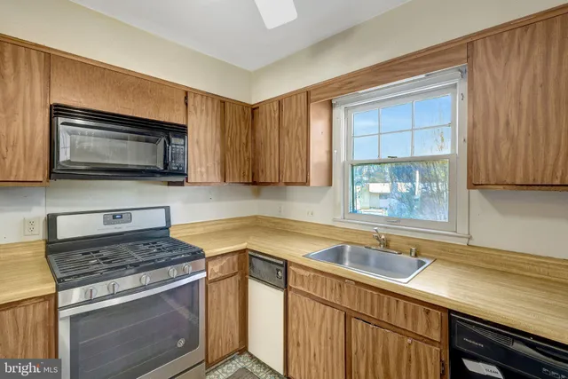 a kitchen with a stove microwave and sink