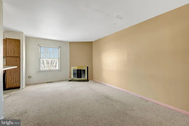 a view of an empty room with a fireplace