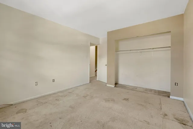 an empty room with closet area