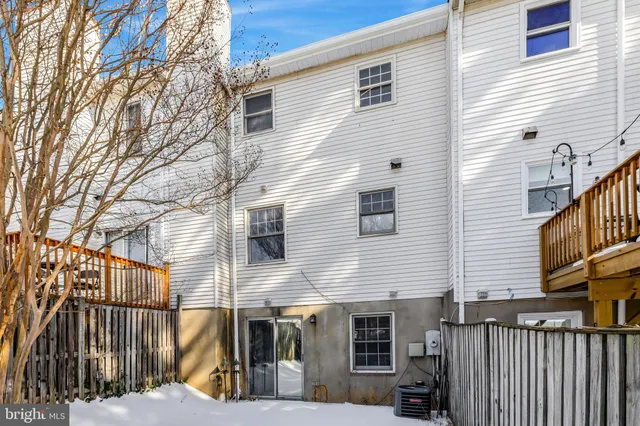 a view of a house with wooden fence