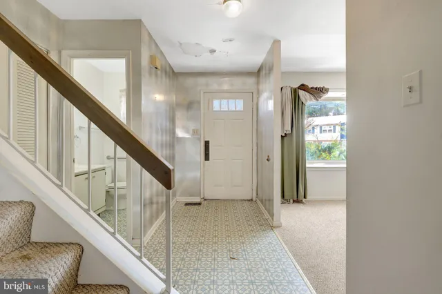 a view of hallway with stairs and wooden floor