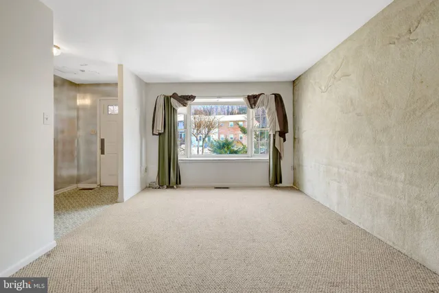 an empty room with windows and mountain view