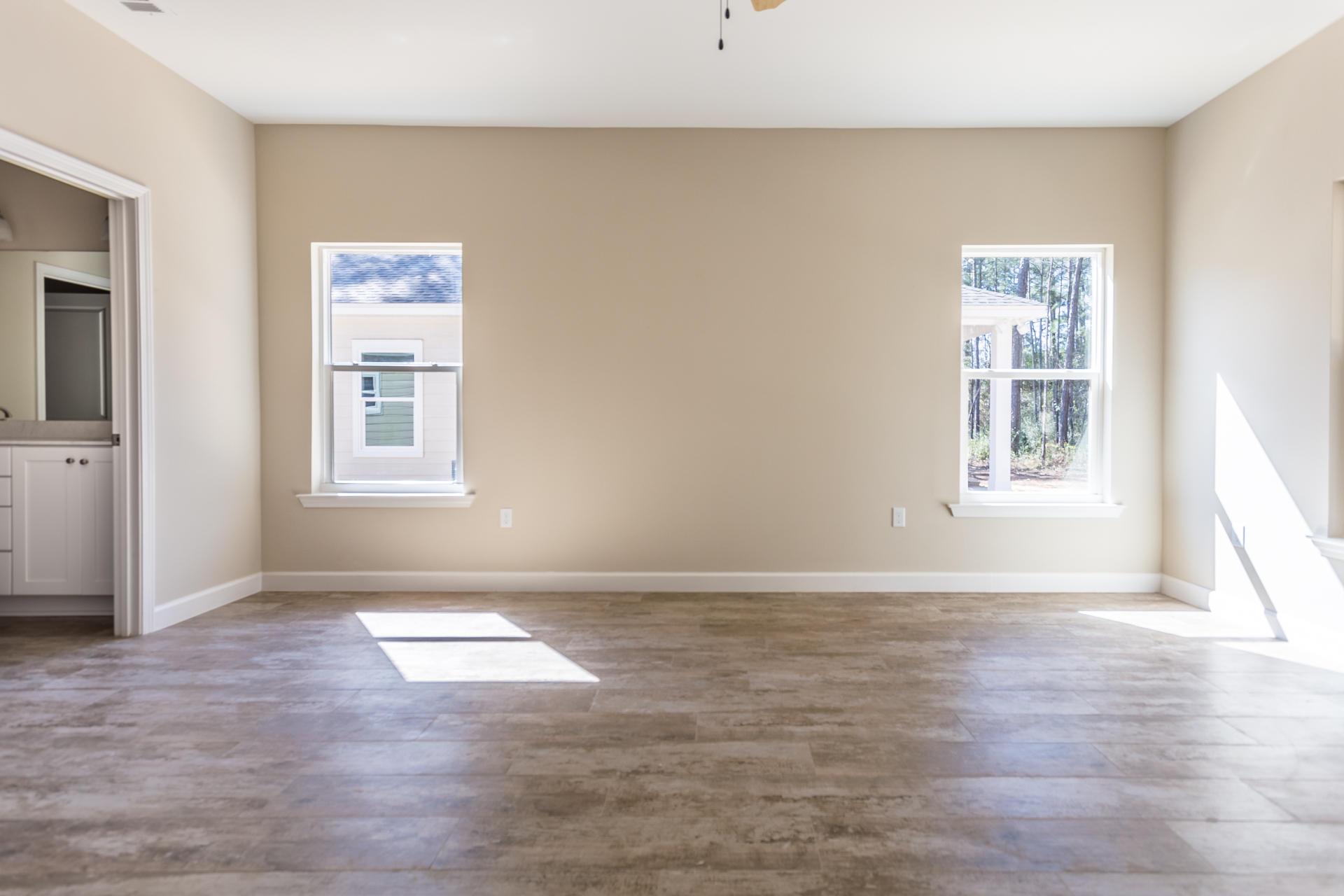343 Indian Woman Road Santa Rosa Beach, FL 32459 - Photo 11 of 21 a view of an empty room with wooden floor and a window